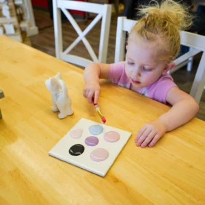 Kid painting pottery 3
